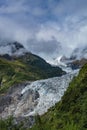 The majestic snow-capped mountains are covered by thick clouds