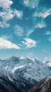Majestic snow-capped mountains under blue sky