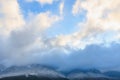 Majestic snow-capped mountains under clear blue sky with clouds Royalty Free Stock Photo