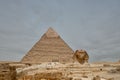 Majestic sphinx sculpture stands guard in front of the iconic pyramids of Giza, Egypt.