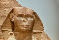 Majestic sphinx sculpture stands guard in front of the iconic pyramids of Giza, Egypt.