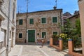 Majestic stone building with vibrant green windowpanes in Porec, Croatia