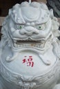 Majestic stone Chinese Guardian Lion statue at Thien Hau Temple with engraved text