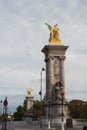 Majestic stone statue on Pont Alexandre III bridge in France