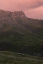 Majestic summer mountain landscape - high orange rocky mountain of canyon in soft pink evening sunset sunlight in overcast weather Royalty Free Stock Photo