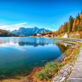 Majestic sunny view of famous Misurina lake during autumn period