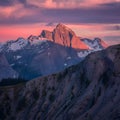 Majestic sunset casts a warm glow over rugged mountain terrain