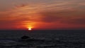 Sunset with dramatic sky and orange and red colored clouds over the horizon of the Atlantic Sea in Essaouira, Morocco, Africa. Royalty Free Stock Photo