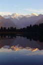 Majestic sunset at Lake Matheson with a reflection of Mount Cook and Mount Tasman in New Zealand. Royalty Free Stock Photo