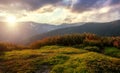 Majestic Sunset in the mountains,hills under warm sunlight. Amazing athmospheric Landscape with overcast sky. Nature background Royalty Free Stock Photo