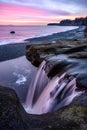 Majestic sunset over a Sandcut waterfall in Sandcut Regional Park, Shirley, Canada
