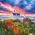 Majestic sunset view of famous Neuschwanstein Castle in autumn Royalty Free Stock Photo