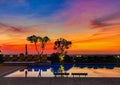 Majestic sunset view over an outdoor swimming pool in a tropical villa Royalty Free Stock Photo