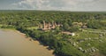 Majestic tradion village at green forested landscape at sand shore aerial view. Wild Indonesia