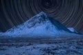 Majestic vibrant star trials long exposure composite image over landscape of snow covered mountain in Winter in Scottish Highlands