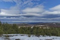 Majestic view of cloudy sky, winter mountain, snowy glade, residential district, conifer and deciduous forest from Plana mountain Royalty Free Stock Photo