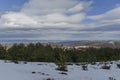 Majestic view of cloudy sky, winter mountain, snowy glade, residential district, conifer and deciduous forest from Plana mountain Royalty Free Stock Photo