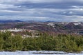 Majestic view of cloudy sky, winter mountain, snowy glade, residential district, conifer and deciduous forest from Plana mountain Royalty Free Stock Photo