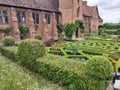 A majestic view of Hatfield House in Hertfordshire towering over manicured lawns and gardens