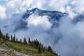 majestic view of moutain peaks through clouds and fog Royalty Free Stock Photo