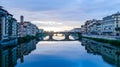 Majestic view of Ponte Vecchio bridge and calm Arno river after thunderstorm in Florence Italy