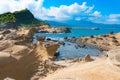 Majestic View of Potholes and Melted Rock Formations With Scattered Clouds in the Background in Yehliu Geopark, Taiwan