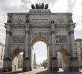 Majestic view of Siegestor in Munich, Germany, with the sun shining from behind it