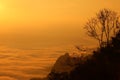 Majestic view of silhouettes of mountains and low clouds at colorful sunrise