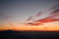 Majestic view of silhouettes of mountains and low clouds at colorful sunset. Royalty Free Stock Photo