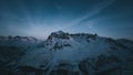 Majestic view of a snow-covered mountain range silhouetted against a clear blue sky Royalty Free Stock Photo