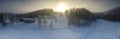 Majestic view of winter sunset with very large sun spot in frozen foggy air, winter pine tree forest, aerial, Grano village,