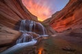 majestic waterfall cascading into fiery canyon sunset