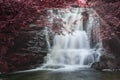 Majestic waterfall in forest landscape image with added drama of false color on trees in woodland Royalty Free Stock Photo