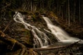 A majestic waterfall in the forests and mountains of Peter Lougheed Provincial Park. Kananaskis Lakes, Alberta. Canada