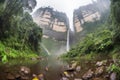 majestic waterfall, with mist and rainbows cascading down the jungle cliffs