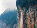 Majestic Waterfall, and Misty Evergreens, Close to Murren in Switzerland. Royalty Free Stock Photo