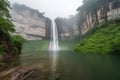 majestic waterfall, plummeting over cliff into misty pool below