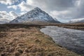 Majestic Winter landscape image of River Etive in foreground with iconic snowcapped Stob Dearg Buachaille Etive Mor mountain in Royalty Free Stock Photo