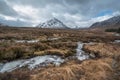 Majestic Winter landscape image of River Etive in foreground with iconic snowcapped Stob Dearg Buachaille Etive Mor mountain in Royalty Free Stock Photo