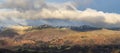 Majestic Winter landscape image view from Holme Fell in Lake District towards snow capped mountain ranges in distance in glorious