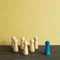 Majority vs minority concept. Wooden human figure on desk. brown background