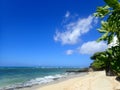Makalei Beach with waves lapping, napakaa, and a lava rock wall that jetty into the ocean Royalty Free Stock Photo