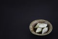 makar sangkranti or poush sangkranti celebration with puli pithe or bengali rice flour dumplings with coconut fillings served on