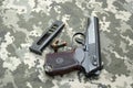 Makarov pistol with cartridges on the background of military camouflage pixel. Royalty Free Stock Photo