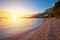 Makarska pebble beach and Biokovo mountain sunset view Royalty Free Stock Photo