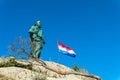 Makarska September 2018 Croatia. Monument to St. Peter and flag of Croatia sea entrance to the Harbor