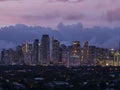 Makati, Metro Manila, Philippines - Afternoon Skyline with pink dramatic sky and city lights. View from Pasong Tamo