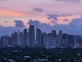 Makati, Metro Manila, Philippines - Jan 2016: Afternoon Skyline with pink dramatic sky and clouds and Dasmarinas Village