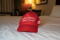 A Make America Great Again red hat sits on a bed. Concept for President Donald Trump re-