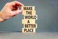 Make a better world symbol. Concept words Make the world a better place on wooden blocks. Beautiful grey table grey background.